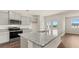 A bright kitchen with gray cabinets, stainless appliances, and granite countertops at 8593 Preakness Pass, Lithonia, GA 30058