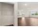 Bright living room features hardwood floors, neutral walls, and natural light through multiple windows and glass patio doors at 8593 Preakness Pass, Lithonia, GA 30058
