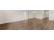 An open living room with hardwood floors and neutral walls at 8593 Preakness Pass, Lithonia, GA 30058