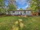 Lush backyard with mature trees and a cozy porch, perfect for outdoor entertaining at 2122 Belhaven Se Ln, Atlanta, GA 30315