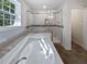 Elegant bathroom featuring a jacuzzi bathtub, glass-enclosed shower, and stylish tile accents at 2122 Belhaven Se Ln, Atlanta, GA 30315