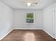 Bedroom with hardwood floors, ceiling fan, and a view to the back yard at 2122 Belhaven Se Ln, Atlanta, GA 30315