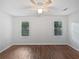 Bedroom featuring wood floors, ceiling fan and two windows providing natural light at 2122 Belhaven Se Ln, Atlanta, GA 30315