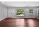 Bright living room with hardwood floors and large windows providing natural light and pleasant outdoor views at 2122 Belhaven Se Ln, Atlanta, GA 30315