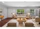Cozy living room featuring neutral furniture, a plush rug, and sunlit windows offering lovely views at 2122 Belhaven Se Ln, Atlanta, GA 30315