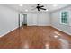 Spacious living room with gleaming hardwood floors, ceiling fan, and natural light from the windows at 2122 Belhaven Se Ln, Atlanta, GA 30315