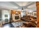 Inviting living room with a fireplace, a wooden accent wall, and plush leather sofas at 5795 Stewart Mill Rd, Douglasville, GA 30135