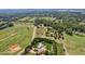 Expansive aerial view of the property showcasing the house, surrounding land, and mature trees at 5365 Crow Rd, Cumming, GA 30041