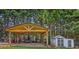 Backyard pavilion, outbuilding, and expansive green space with mature trees at 5365 Crow Rd, Cumming, GA 30041