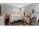 Cozy bedroom featuring a decorated bed, wood floors, and a matching nightstand and dresser at 5365 Crow Rd, Cumming, GA 30041