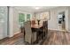 Charming dining room with wood table, seating for six, and a large window with natural light at 5365 Crow Rd, Cumming, GA 30041