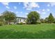 Well-manicured lawn surrounds this home, complemented by mature trees and lush landscaping at 5365 Crow Rd, Cumming, GA 30041