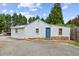 Charming home featuring stone accents, a blue front door, and well-maintained landscaping at 5365 Crow Rd, Cumming, GA 30041