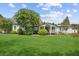 Inviting home with a manicured lawn, mature trees, and a charming front porch and exterior at 5365 Crow Rd, Cumming, GA 30041