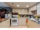 Functional kitchen with ample cabinet space, tiled countertops, and appliances at 5365 Crow Rd, Cumming, GA 30041