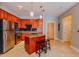 Kitchen featuring an island, tile floors, stainless steel appliances, and wood cabinets at 799 Hammond Dr # 406, Atlanta, GA 30328