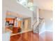 Bright living room featuring hardwood floors, staircase, and modern lighting fixtures at 799 Hammond Dr # 406, Atlanta, GA 30328