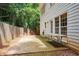 Cozy backyard patio featuring a table, fence, and view of the home's white siding at 295 Vickery Way, Roswell, GA 30075