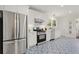 Modern kitchen features stainless steel appliances, white cabinetry, and eye-catching patterned tile floors at 1789 Thompson Ave, Atlanta, GA 30344