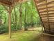 Wood deck with wood supports overlooking wooded area and black metal fence at 1269 Heritage Dr, Villa Rica, GA 30180