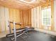 Unfinished basement area with exposed wood framing and work out area at 1269 Heritage Dr, Villa Rica, GA 30180