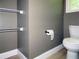 Bathroom with toilet, open shelves, and neutral-toned walls at 1269 Heritage Dr, Villa Rica, GA 30180