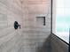Modern bathroom with a shower featuring neutral tile and a convenient recessed niche at 1269 Heritage Dr, Villa Rica, GA 30180