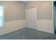 Bedroom with carpet, a closet and paneled walls, bathed in natural light from the window at 1269 Heritage Dr, Villa Rica, GA 30180