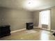 Bedroom with hardwood floors, neutral walls, and a window with white curtains at 1269 Heritage Dr, Villa Rica, GA 30180