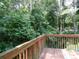 A peaceful view from the wooden deck surrounded by lush greenery at 1269 Heritage Dr, Villa Rica, GA 30180