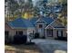 Brick home with gray roof, two-car garage, and landscaping at 1269 Heritage Dr, Villa Rica, GA 30180