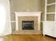 Cozy brick fireplace with white mantel and built in shelving in the adjacent living room at 1269 Heritage Dr, Villa Rica, GA 30180