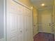 Hallway with hardwood floors, multiple doors, and closet space, offering practicality at 1269 Heritage Dr, Villa Rica, GA 30180