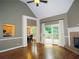 Open concept living room with fireplace, hardwood floors, and access to an outdoor deck at 1269 Heritage Dr, Villa Rica, GA 30180