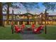 Inviting fire pit area with Adirondack chairs and string lights for relaxing evenings at 947 Willingham Dr # 2, Hapeville, GA 30354