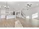 Open concept living area with modern lighting, hardwood floors, and a staircase at 947 Willingham Dr # 2, Hapeville, GA 30354