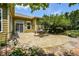 Beautiful outdoor patio space with landscaped garden beds, shade trees, and tranquil atmosphere at 705 Springer Mountain Dr, Canton, GA 30114