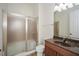 Bathroom featuring glass shower and a granite vanity top and an illuminated mirror at 705 Springer Mountain Dr, Canton, GA 30114