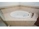 Soaking tub with tile surround, perfect for relaxing after a long day at 705 Springer Mountain Dr, Canton, GA 30114