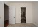 Bedroom featuring doors to ensuite bath and to another room with hardwood floors at 705 Springer Mountain Dr, Canton, GA 30114