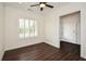 Well-lit bedroom featuring wood floors, crown molding, and a window with shutters at 705 Springer Mountain Dr, Canton, GA 30114