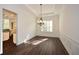 Dining room featuring hardwood floors, modern chandelier, and wainscoting for a stylish space at 705 Springer Mountain Dr, Canton, GA 30114