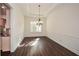 Dining room featuring hardwood floors, modern chandelier, and wainscoting for a stylish space at 705 Springer Mountain Dr, Canton, GA 30114