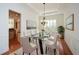 Modern dining room featuring hardwood floors, modern chandelier, and plenty of sunshine at 705 Springer Mountain Dr, Canton, GA 30114
