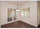 Bright dining area with a view of a treed yard and French doors that allow for outdoor light to illuminate the room at 705 Springer Mountain Dr, Canton, GA 30114