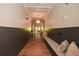 Hallway showcasing wood floors, custom trim, and seating area at 705 Springer Mountain Dr, Canton, GA 30114