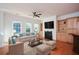 Living room with hardwood floors, fireplace, built-in shelves, and a large window at 705 Springer Mountain Dr, Canton, GA 30114