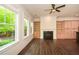 Bright living room with a fireplace, built-in cabinets and shelves, and large windows at 705 Springer Mountain Dr, Canton, GA 30114