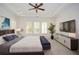 Modern main bedroom with blue decor, carpet, plantation shutters, tray ceilings and TV at 705 Springer Mountain Dr, Canton, GA 30114