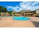 Community pool with a spacious deck, lounge chairs, and a clubhouse in the background at 705 Springer Mountain Dr, Canton, GA 30114
